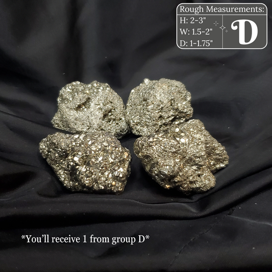 Four metallic pyrite crystals on a black fabric background with measurements and text overlay.