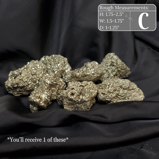 Pile of metallic rocks on a black background with measurements displayed.